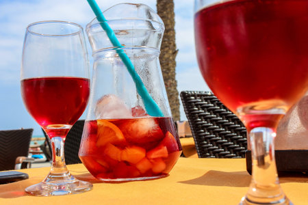 Sangria pitcher in a spanisch beach bar, nice view and a blue skyの写真素材