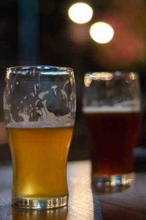 A vertical shot of glasses of beer on the tableの写真素材