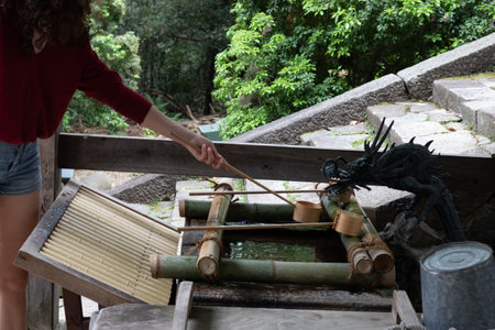 A female pouring water with cupの写真素材