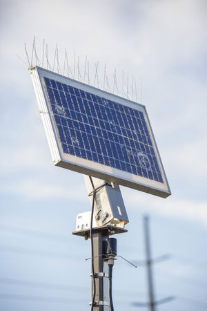 A damaged solar panel against the cloudy skyの写真素材