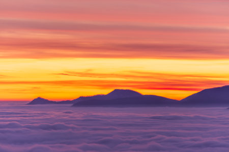 Sea of fog and Snow-capped Mountain in Sunset with Colorful Sky in Ticino, Switzerlandの写真素材