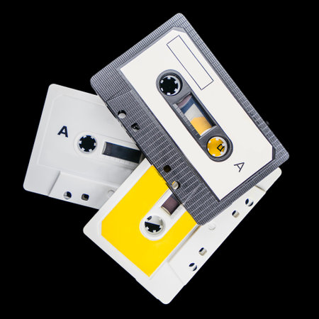 A closeup shot of old cassettes isolated on black backgroundの写真素材