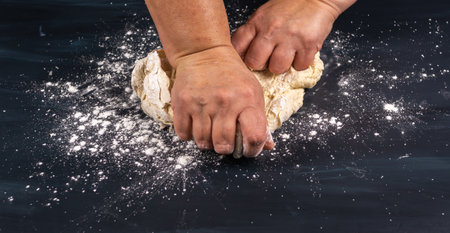 homemade bread dough with flour, salt, egg, water and yeast, with a black backgroundの写真素材