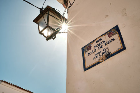 A street name sign on a building in Alvor, Algarve, Portugalの写真素材