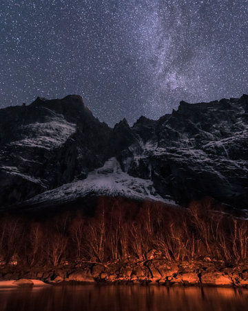 A vertical shot of rocky hills under a starry sky at night - perfect for wallpapers and backgrounds