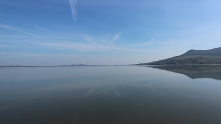 A beautiful front reflection of the hills in the reservoir at Palava, Czech republicの写真素材