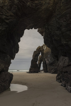 A vertical shot of the beach in the Province of Galicia, Spain during daylightの写真素材