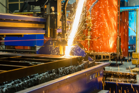 A closeup shot of sparks flying from an industrial steel cutter