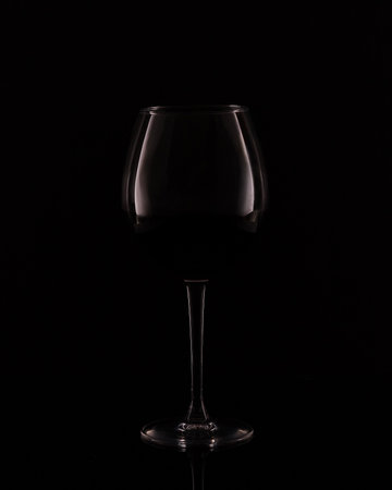 Wine glass on a black background. Minimalist concept.の写真素材