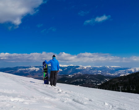 A back view of a snowboarder on a slopeの写真素材