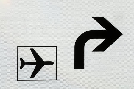 A closeup of a plane and arrow signs on a board in Germanyの写真素材
