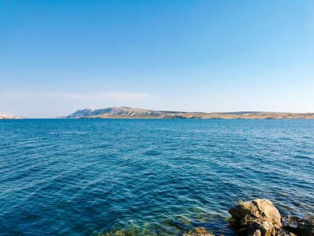 Beautiful summer scenery with arid coastline in background of blue sea. Amazing landscape with sea and coast in summer on Pag Island in Croatia.の写真素材