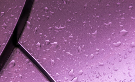 A closeup shot of water droplets on a purple windowの写真素材