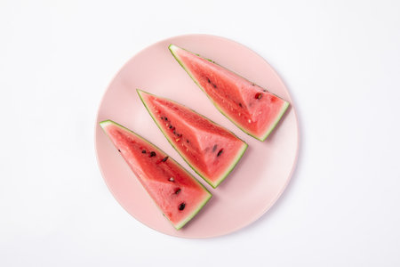 A top view of fresh watermelon on the plate isolated on white background