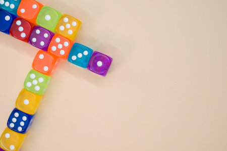 A top view of transparent colorful dice on pastel orange surface for a copy spaceの写真素材