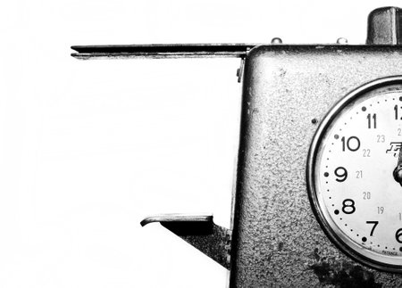A black-and-white close-up photo of an old watch on a white backgroundの写真素材