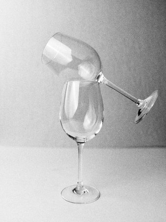 A vertical shot of two drinking glasses on a gray surfaceの写真素材