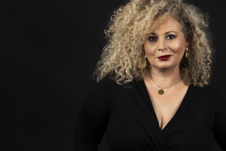 A portrait of a female plus-size model with on a black backgroundの写真素材