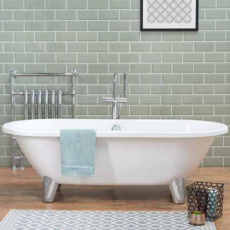A bathtub in a bathroom with laminate flooring and ceramic tiled wall, a loft style apartmentの写真素材