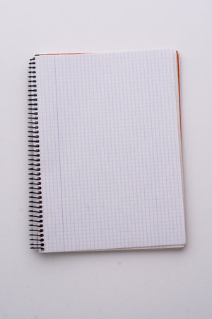 A checked notebook isolated on a white backgroundの写真素材
