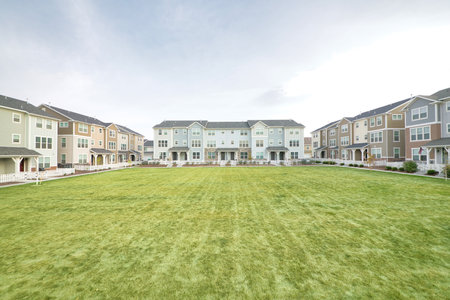 A beautiful shot of modern residential buildings seen through a fresh green lawnの写真素材