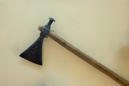 An old tomahawk axe against a yellow backgroundの写真素材