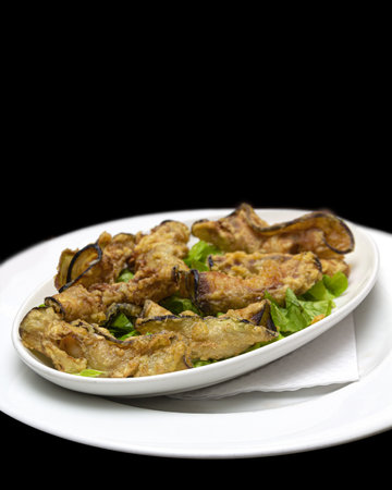 A dish of crispy fried eggplants served restaurant style.の写真素材