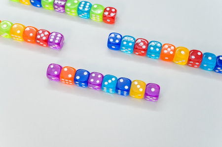 A closeup of colorful transparent dice on white background for a copy spaceの写真素材