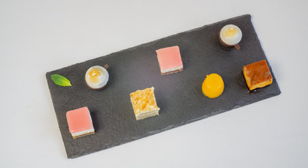 delicious assorted cupcakes of different flavors and colors on white backgroundの写真素材