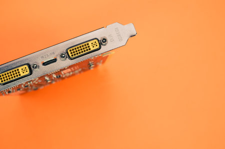 A top view of a computer graphics card on an orange backgroundの写真素材