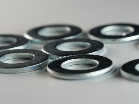 A closeup shot of flat washers on a white surface