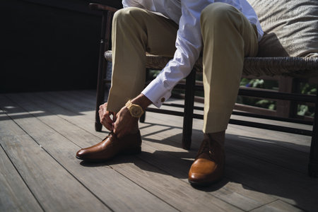 A closeup shot of a man wearing classic leather shoesの写真素材