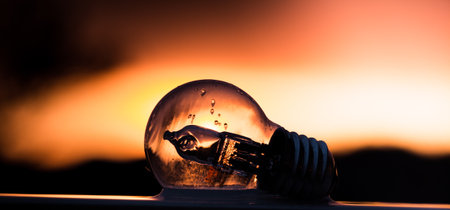 The light bulb against beautiful sunset backgroundの写真素材