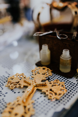 A vertical shot of a golden cross on a white tableclothの写真素材