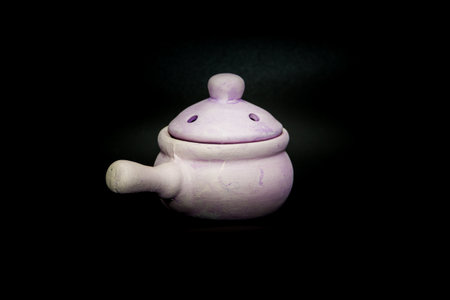 Ceramic incense bowl for aromatic smoke bombs isolated on black backgroundの写真素材