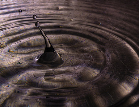 The water drop splash creating ripplesの写真素材