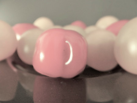 A soft focus of whole cherry tomatoes with washed out effect on a dining table