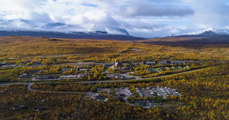 Aerial drone view of the Abisko town, in middle of foliage nature, on a sunny autumn day, in Lappland, Norrbotten, Swedenの写真素材