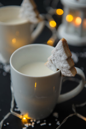A vertical shot of cup of milk with Christmas cookieの写真素材