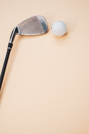 A vertical shot of a golf ball and a club isolated on a pink background with copyspaceの写真素材