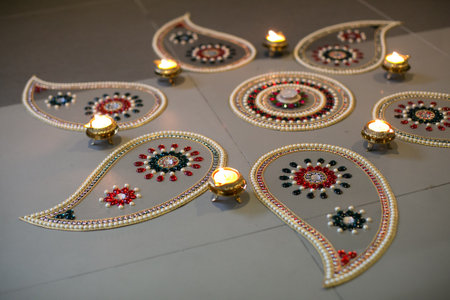 The candles and flower rangoli on the floorの写真素材