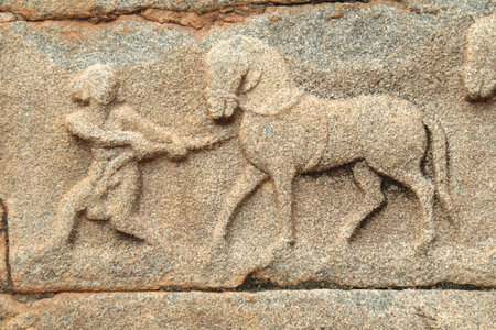 A horseman pulling the reluctant horse - a wall carving on Mahanavami Dibba, Hampiの写真素材