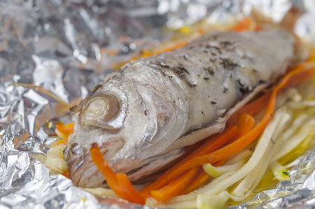 A closeup shot of baked fish in foilの写真素材