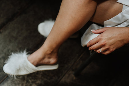 The bride wearing a white loose dress and slippers with a blurry backgroundの写真素材