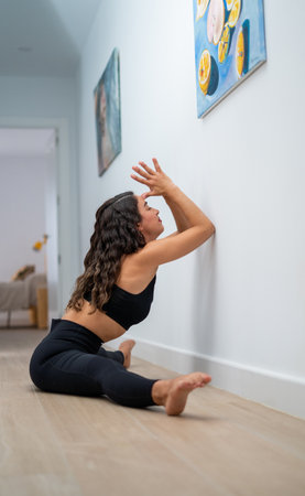 A vertical shot of a white Caucasian woman exercising on the floorの写真素材