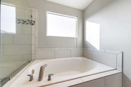 A modern interior of a bathroom with a big bathtub