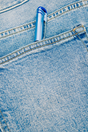 A vertical shot of a pen in a pocket of jeansの写真素材