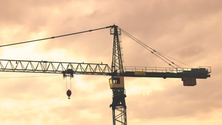 A shot of a crane against a sunset skyの写真素材