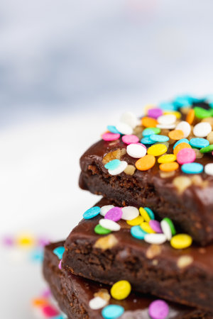 The delicious chocolate brownies with colorful sprinklesの写真素材