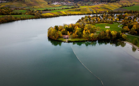 An aerial shot of water surface near colorful fieldsの写真素材